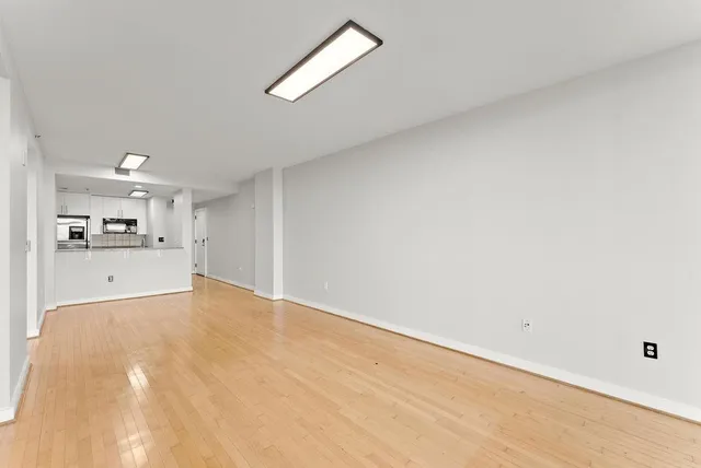 a view of kitchen and empty room