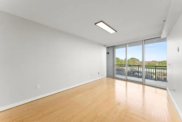 wooden floor in an empty room with a window