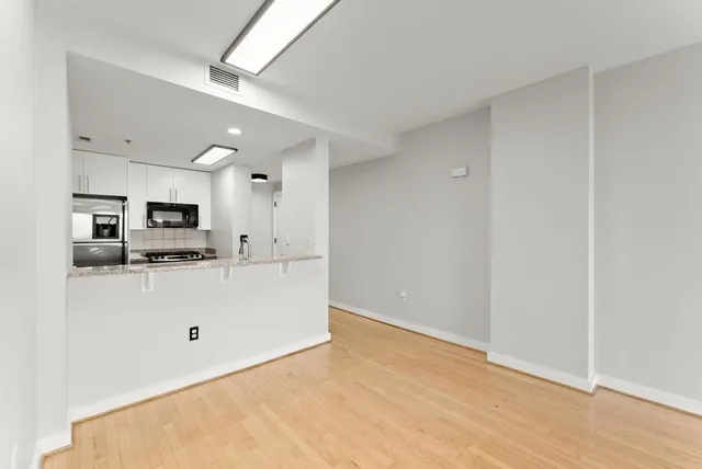 a view of a kitchen with stainless steel appliances a refrigerator