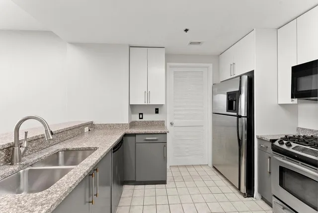 a kitchen with a sink stove and refrigerator