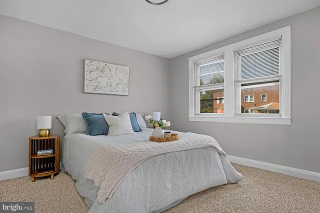 a bedroom with bed and window