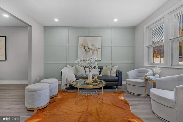 a living room with furniture a chandelier and a table