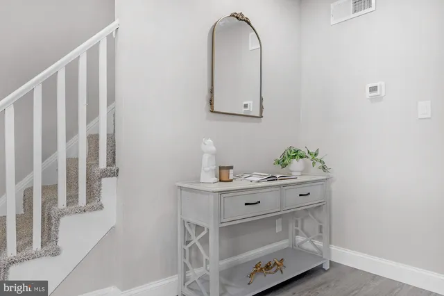 a utility room with cabinets and wooden floor