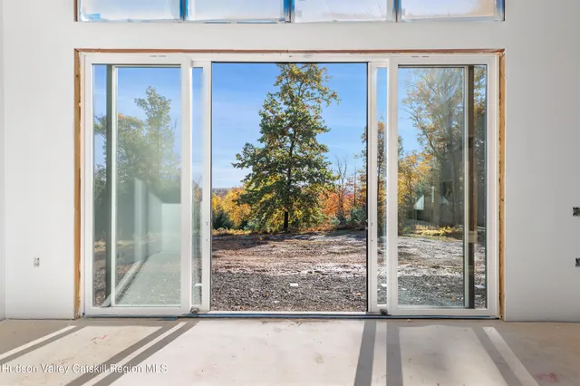 a view of an empty room with glass door