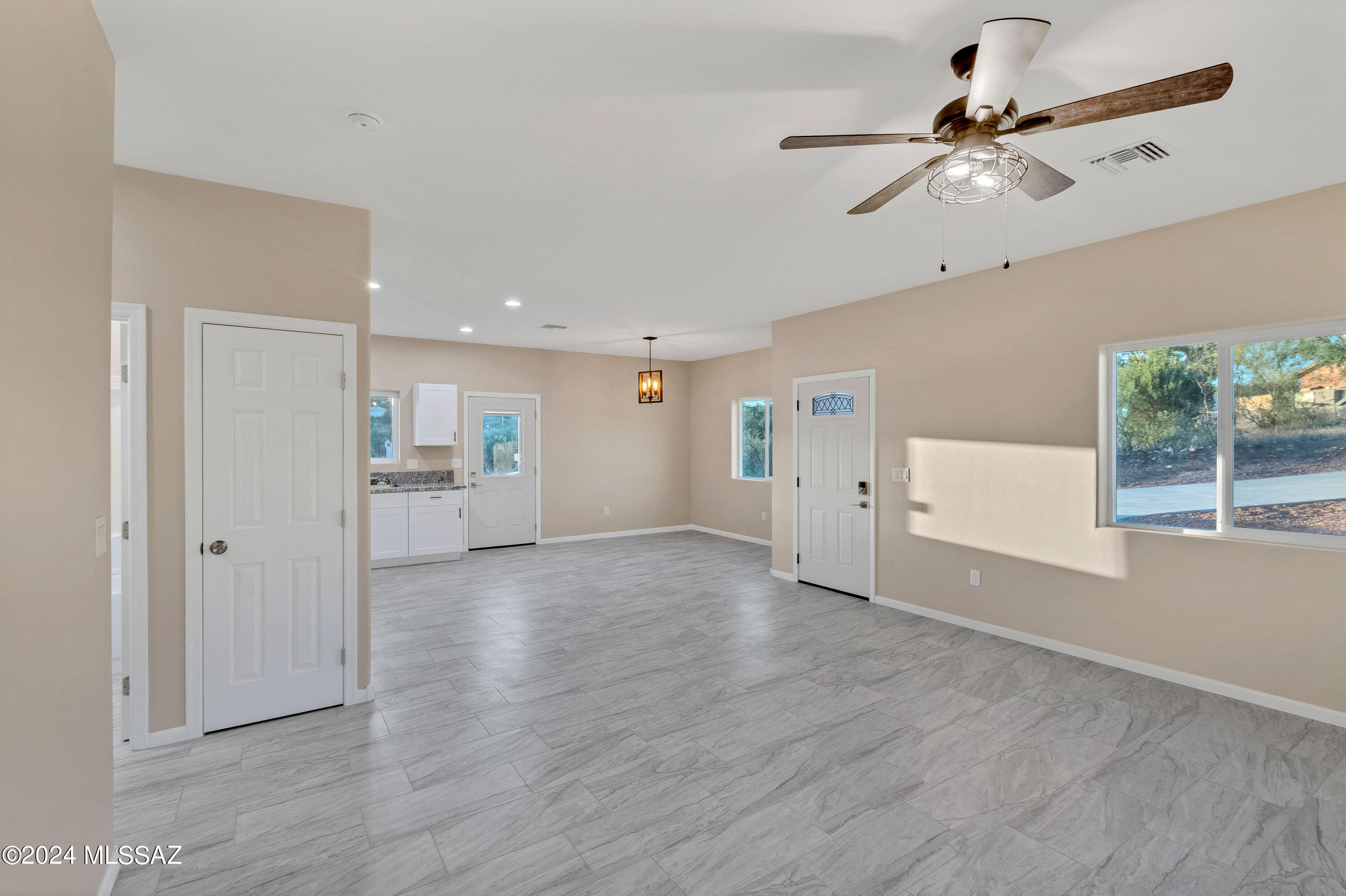 356 Globo Court Rio Rico, AZ 85648 - Photo 6 of 32 a view of empty room with wooden floor and window