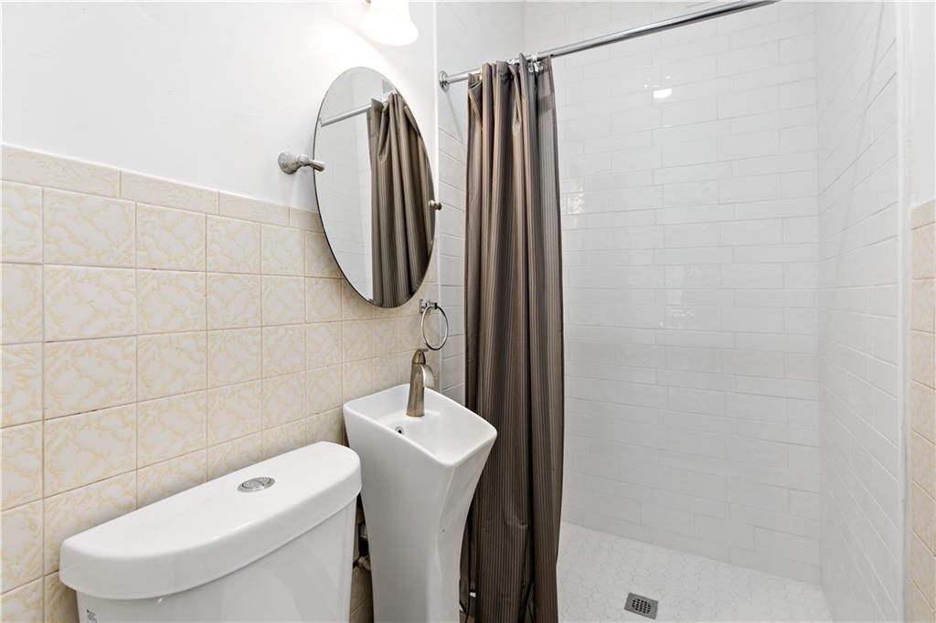 428 Card Avenue Wilmerding, PA 15148 - Photo 11 of 32 a bathroom with a toilet and a sink