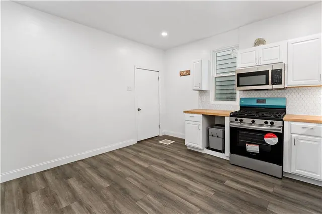 a kitchen with stainless steel appliances a stove a microwave and a refrigerator