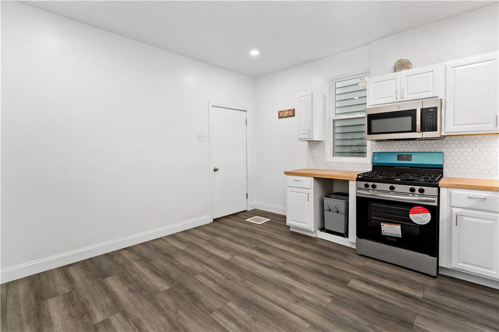 428 Card Avenue Wilmerding, PA 15148 - Photo 13 of 32 a kitchen with stainless steel appliances a stove a microwave and a refrigerator