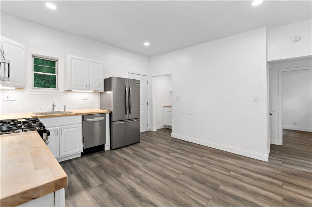 428 Card Avenue Wilmerding, PA 15148 - Photo 14 of 32 a kitchen with a refrigerator sink and cabinets