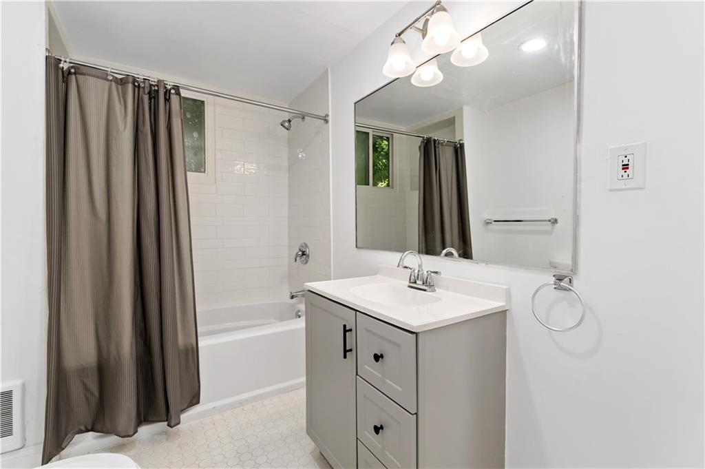 428 Card Avenue Wilmerding, PA 15148 - Photo 19 of 32 a bathroom with a sink a mirror a vanity and a shower
