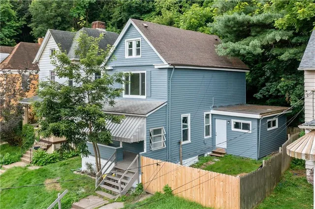 a aerial view of a house with yard and sitting area