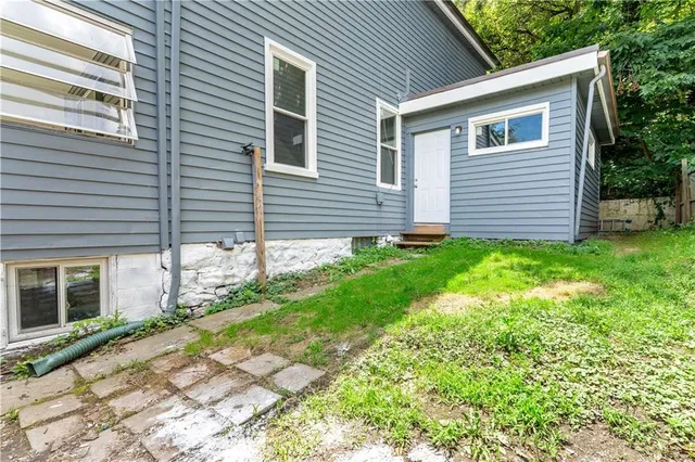 an aerial view of a residential apartment building with a yard and parking spaces