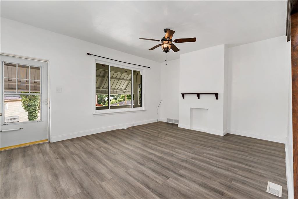 428 Card Avenue Wilmerding, PA 15148 - Photo 5 of 32 a view of an empty room with a window and wooden floor