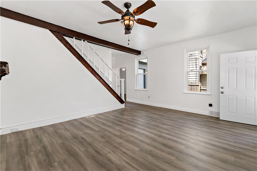428 Card Avenue Wilmerding, PA 15148 - Photo 6 of 32 an empty room with wooden floor fan and windows