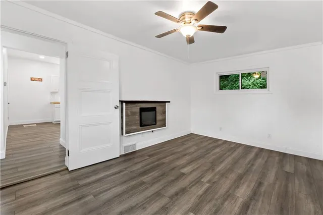 wooden floor in an empty room with a fireplace