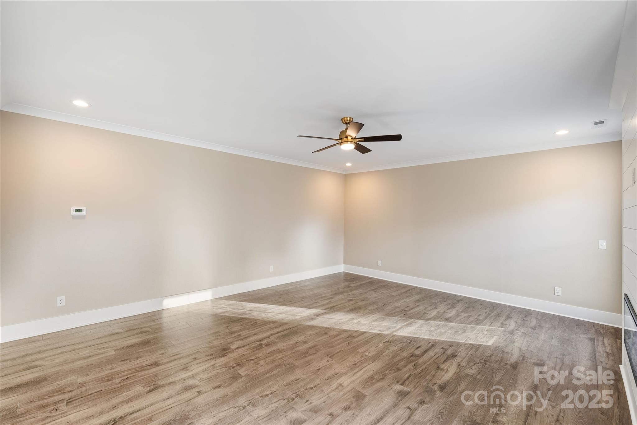 1917 Snyders Store Road, Unit 6 Wingate, NC 28174 - Photo 12 of 46 a view of a big room with wooden floor and windows in a room