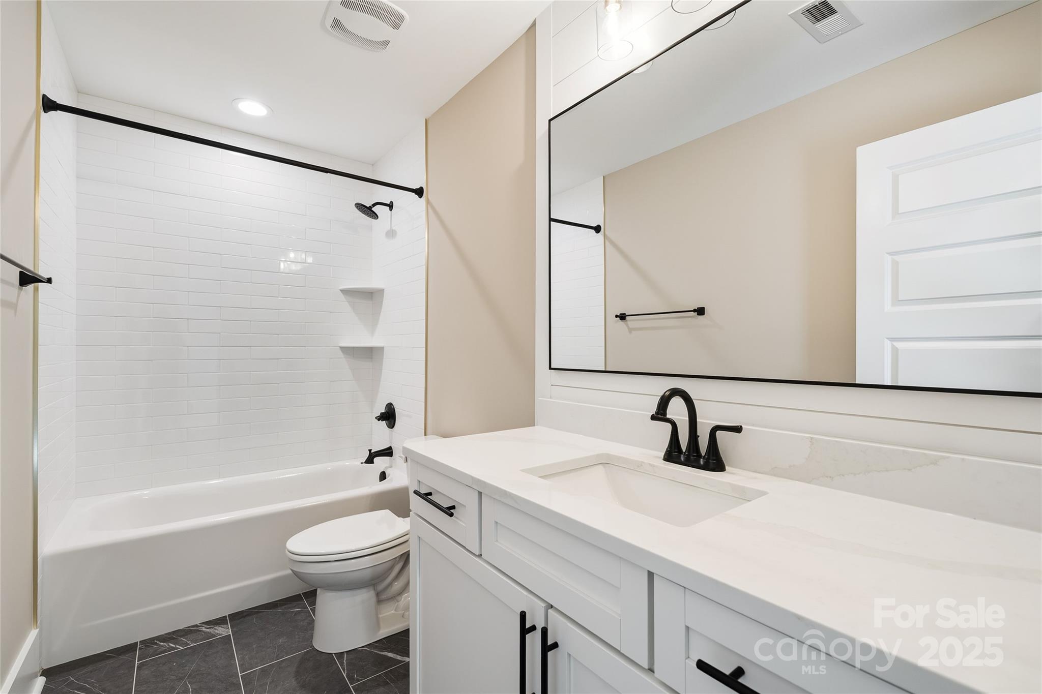 1917 Snyders Store Road, Unit 6 Wingate, NC 28174 - Photo 34 of 46 a bathroom with a sink a toilet and a bathtub