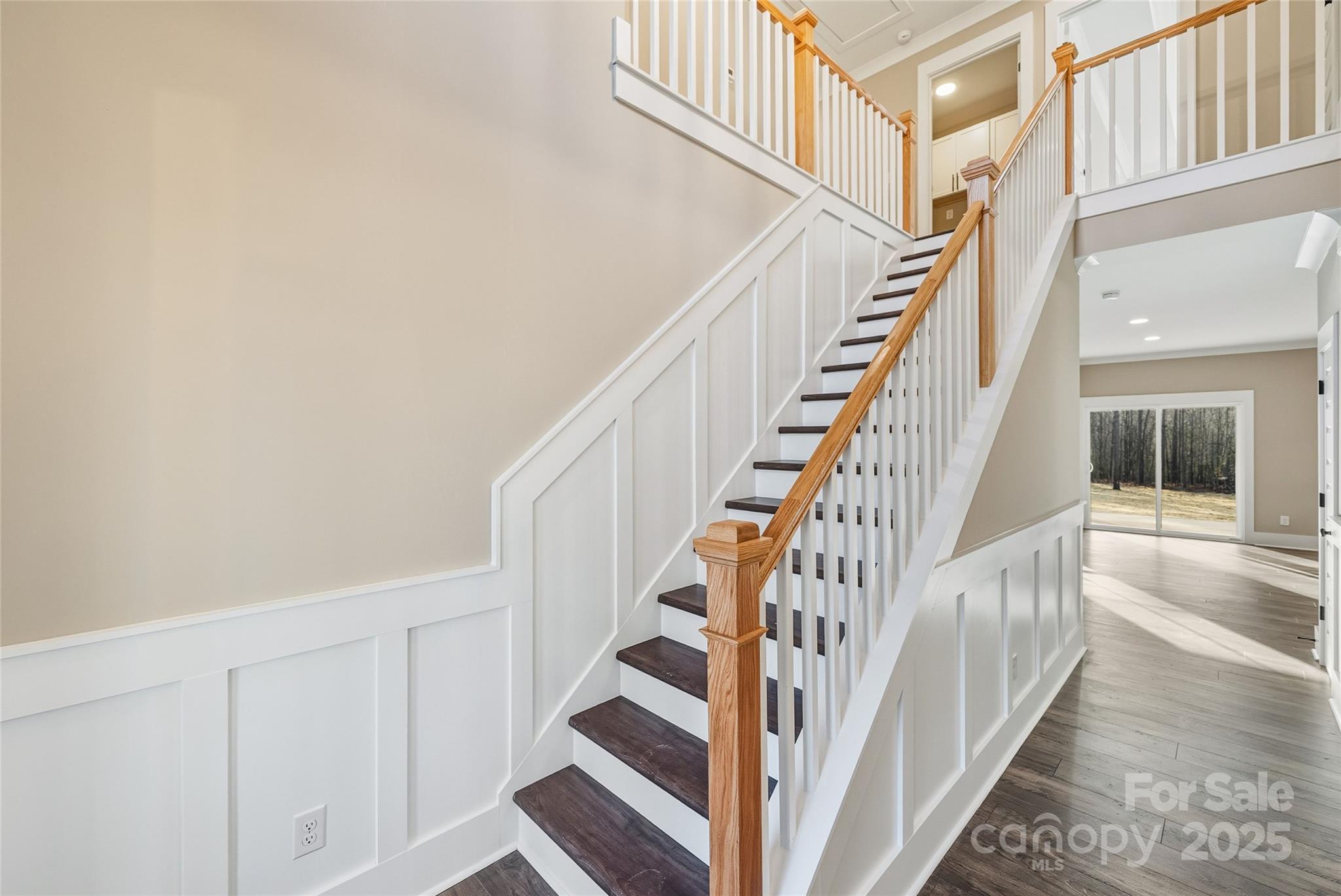1917 Snyders Store Road, Unit 6 Wingate, NC 28174 - Photo 6 of 46 a view of staircase with lots of frames on wall and wooden floor