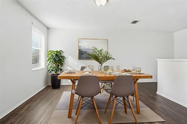 a dining room with furniture and wooden floor