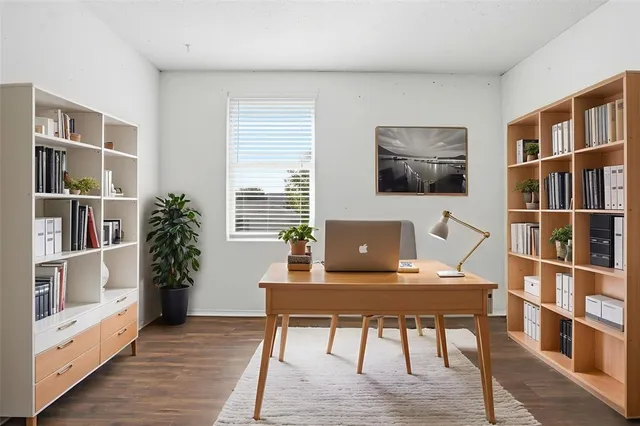 a view of a workspace with furniture and a bookshelf