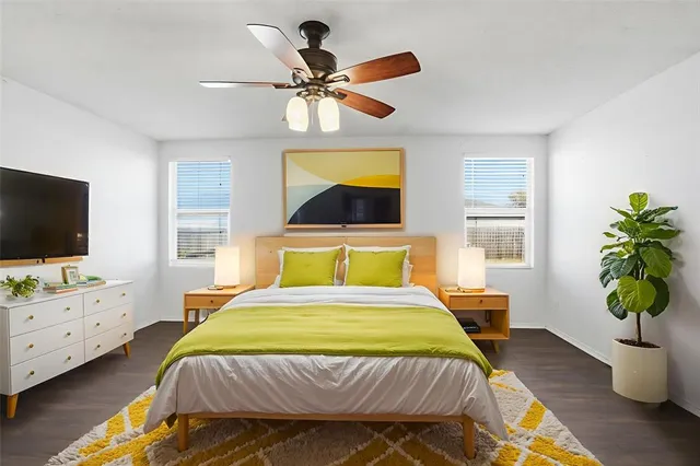 a bedroom with a bed and a flat screen tv