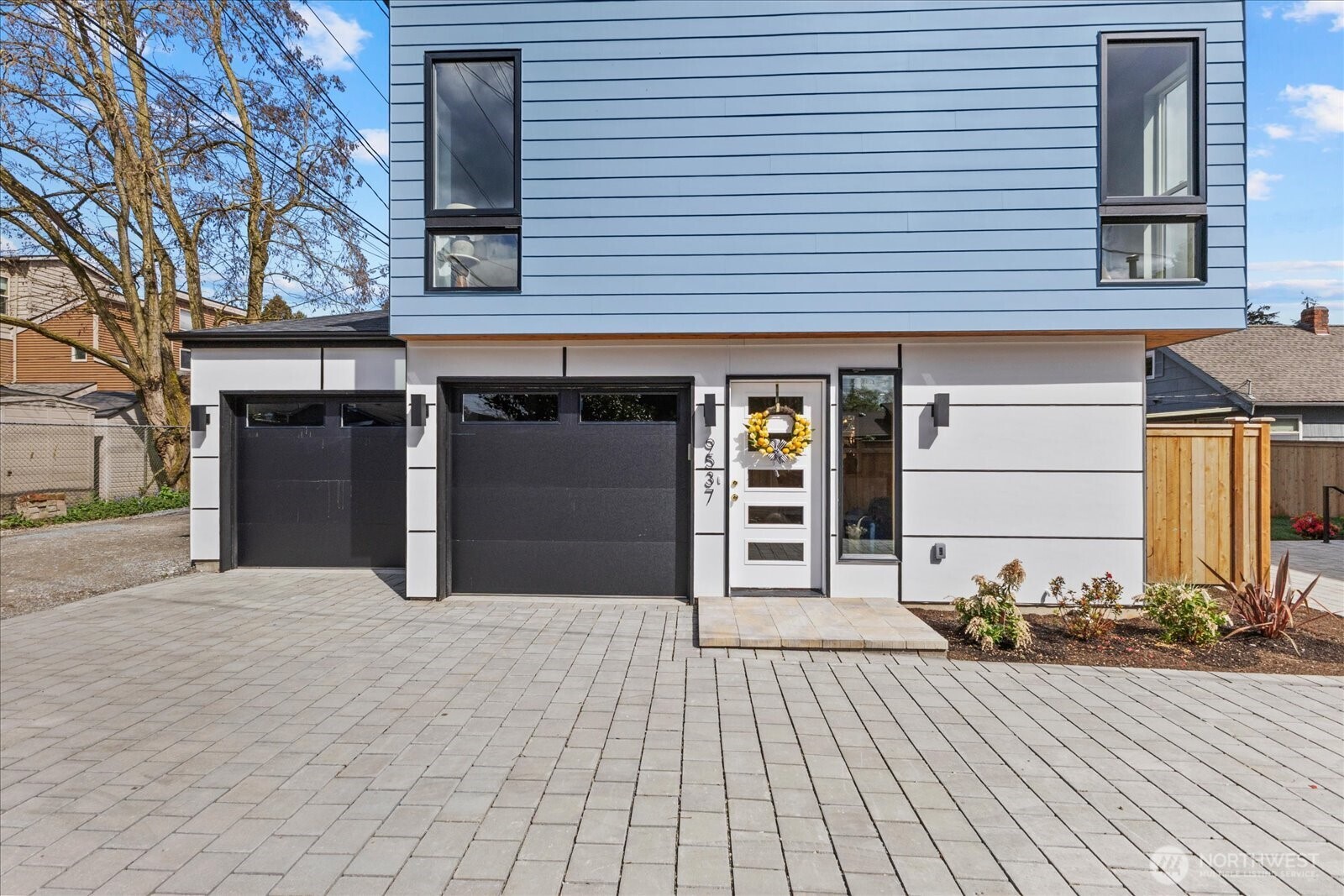 9537 Dayton Avenue North Seattle, WA 98103 - Photo 1 of 22 a front view of a house with a yard and garage