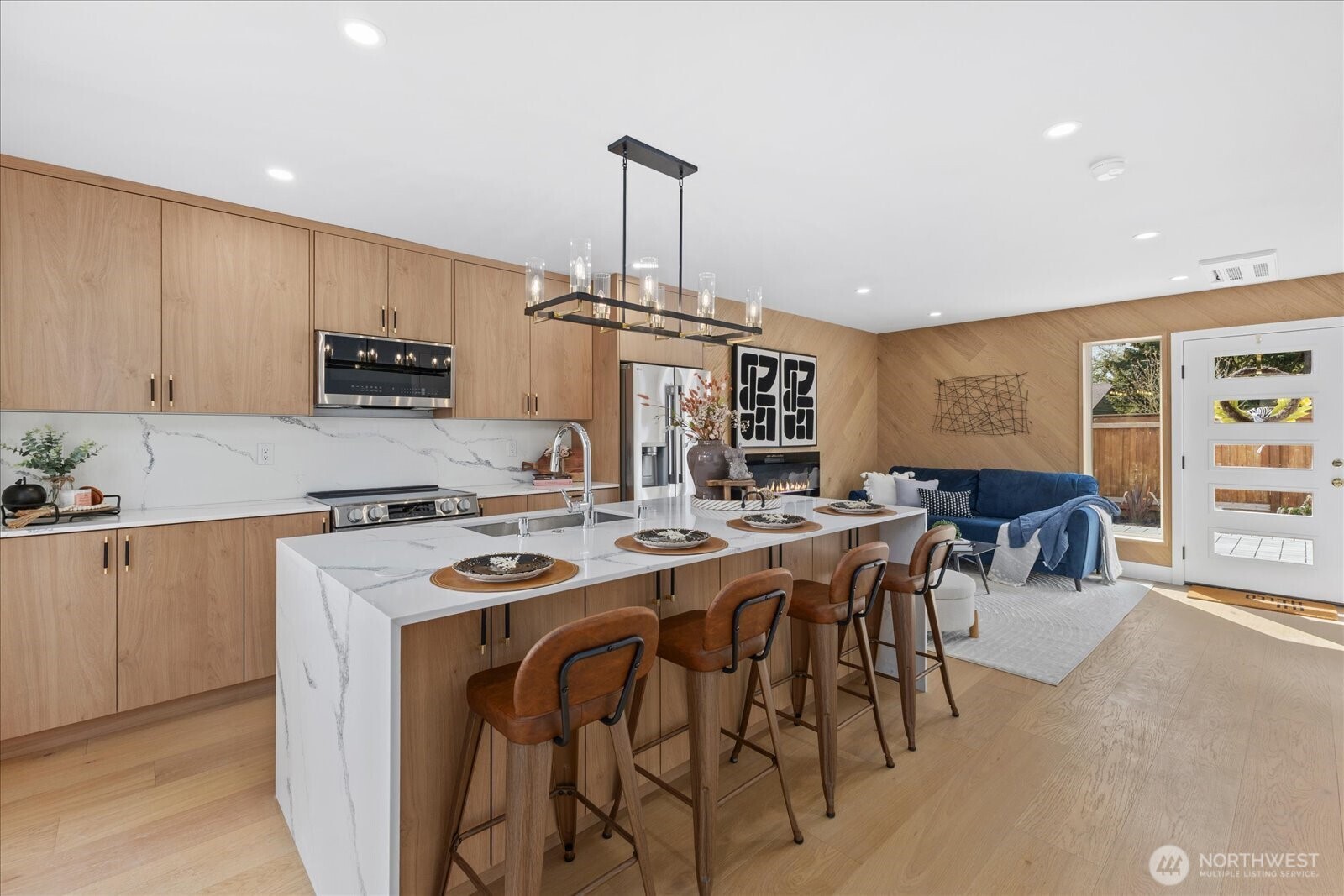 9537 Dayton Avenue North Seattle, WA 98103 - Photo 11 of 22 a kitchen with stainless steel appliances a stove a sink a oven a dining table and chairs