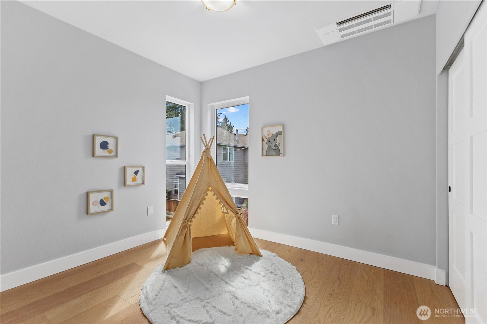 9537 Dayton Avenue North Seattle, WA 98103 - Photo 17 of 22 a room with wooden floor and a potted plant