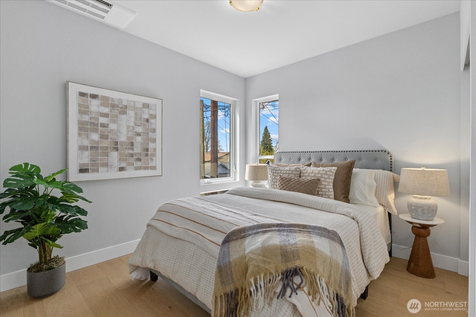 9537 Dayton Avenue North Seattle, WA 98103 - Photo 18 of 22 a bedroom with bed and a potted plant