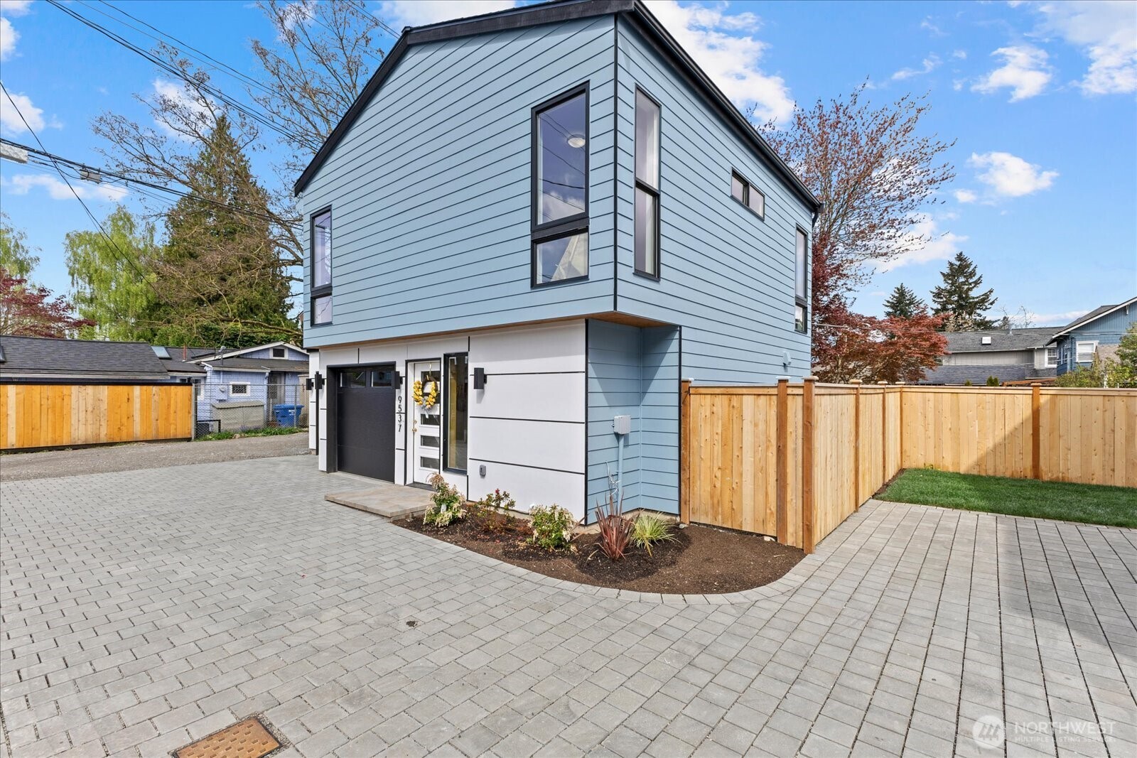 9537 Dayton Avenue North Seattle, WA 98103 - Photo 2 of 22 a front view of a house with a yard and garage