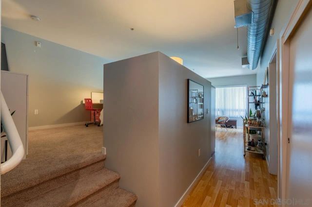 a hallway with furniture and wooden floor