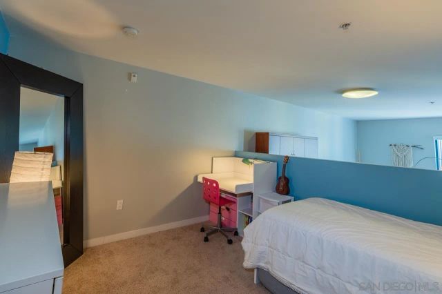 a bedroom with a bed and chair