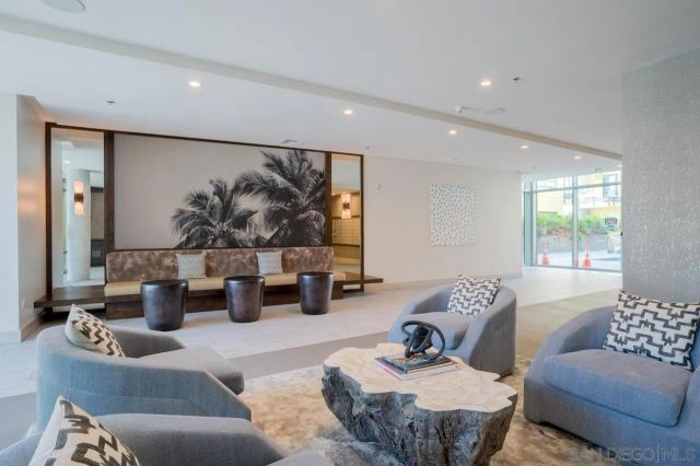 a view of a patio with couches and table and chairs and potted plants