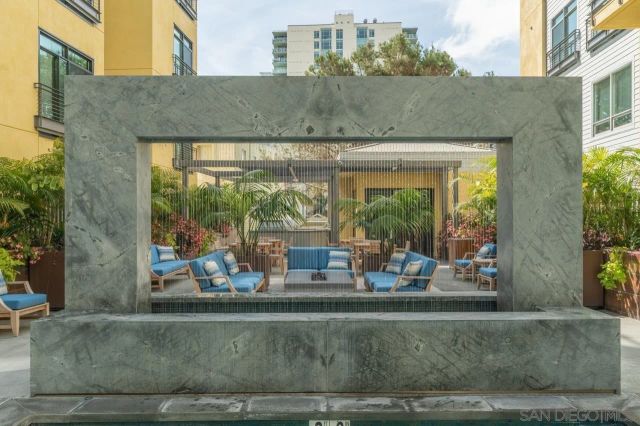 a view of a patio with couches and a potted plant on a table