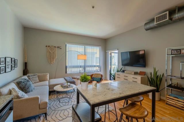 a view of a livingroom with furniture and a flat screen tv