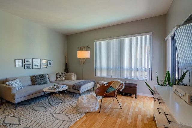 a living room with furniture and wooden floor