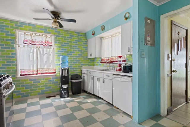 a kitchen with a cabinets appliances and a window