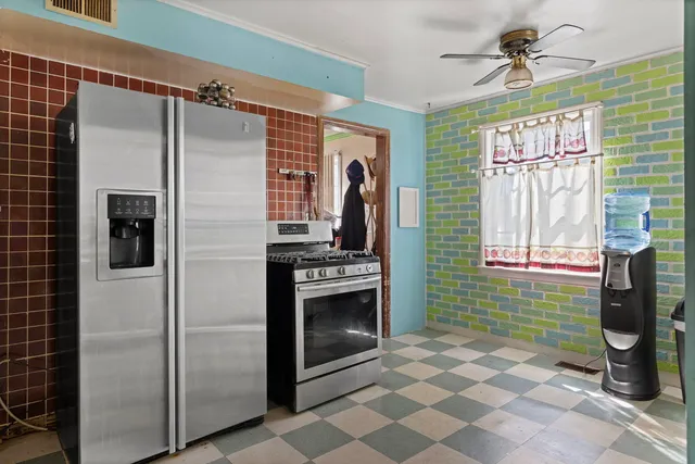 a kitchen with a refrigerator and a sink