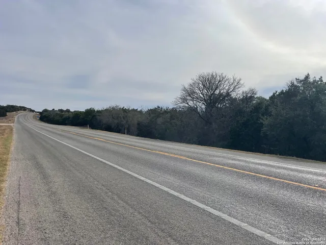 a view of a field with trees in the background