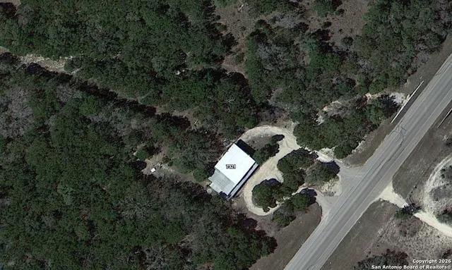 an aerial view of a house with outdoor space and street view