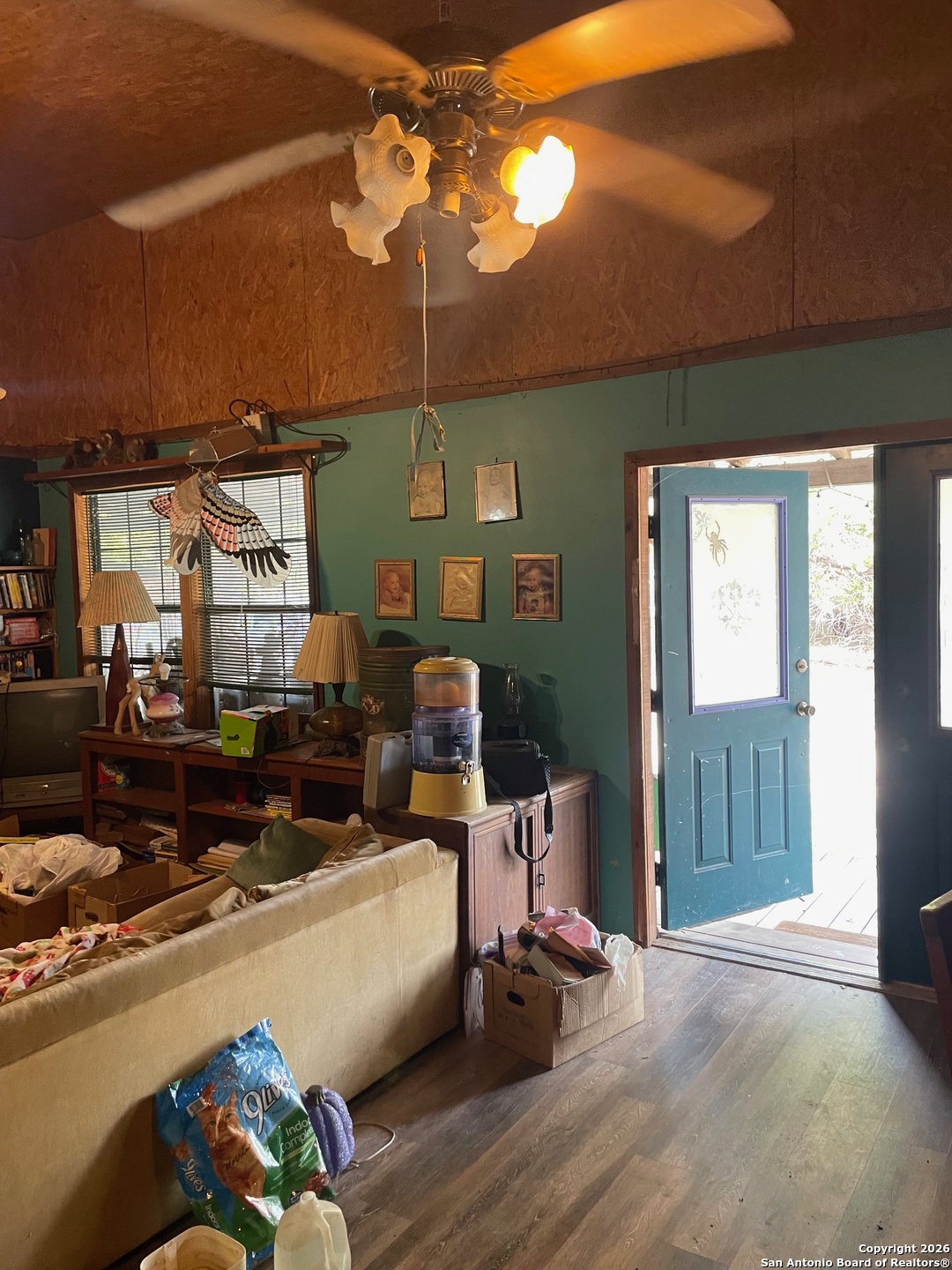 7321 Highway 173 Bandera, TX 78003 - Photo 7 of 28 a living room with furniture a chandelier and a window