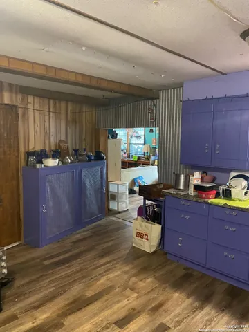 a kitchen with stainless steel appliances granite countertop wooden cabinets a stove and a sink