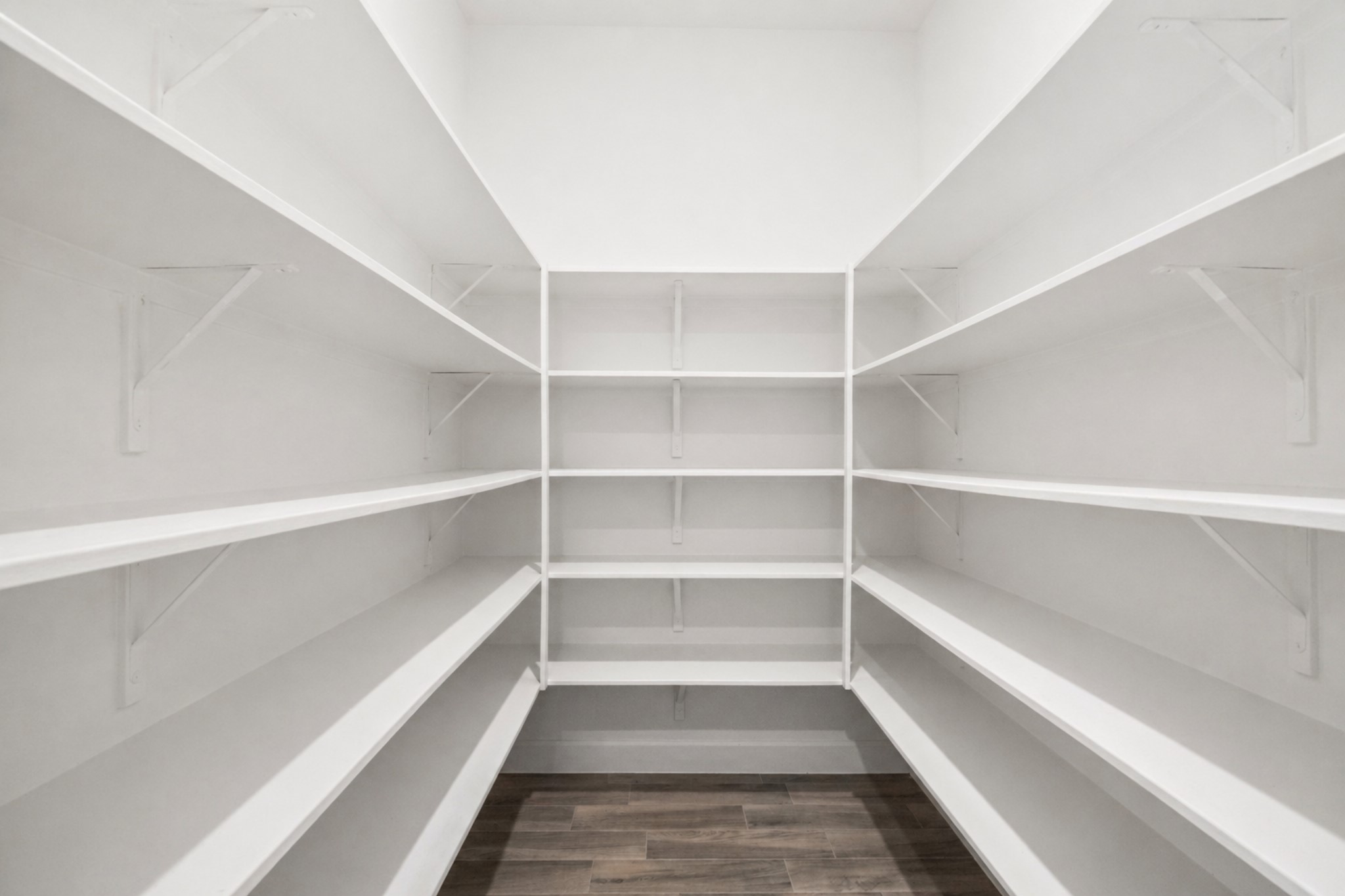 3118 Swift Way Katy, TX 77493 - Photo 9 of 34 Pantry – A spacious walk-in pantry with extensive shelving, providing exceptional storage and organization for kitchen essentials.
