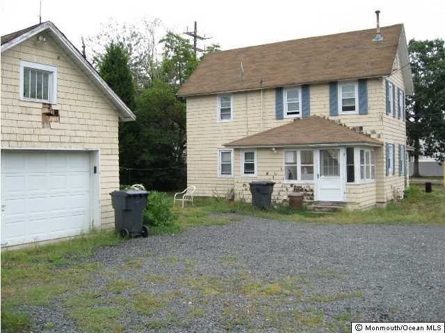 241 Drum Point Road Brick, NJ 08723 - Photo 2 of 3 a front view of a house with a yard