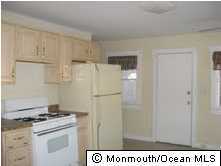 241 Drum Point Road Brick, NJ 08723 - Photo 3 of 3 a kitchen with a stove and a refrigerator