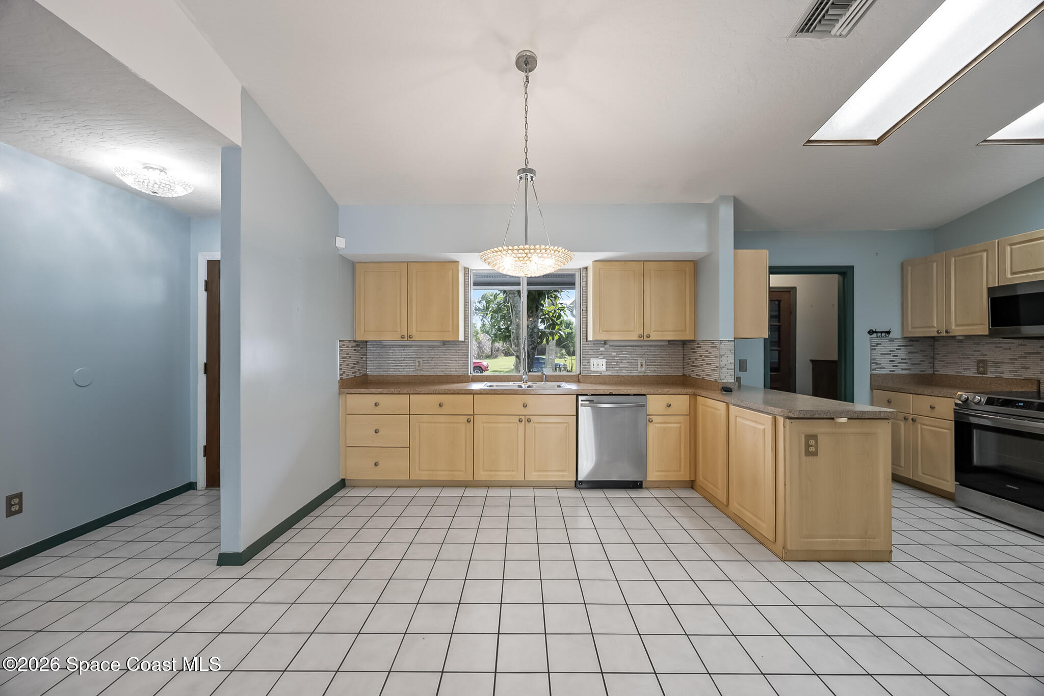 854 Dale Circle Sebastian, FL 32958 - Photo 11 of 31 a kitchen with a stove a sink dishwasher a refrigerator and white cabinets with wooden floor