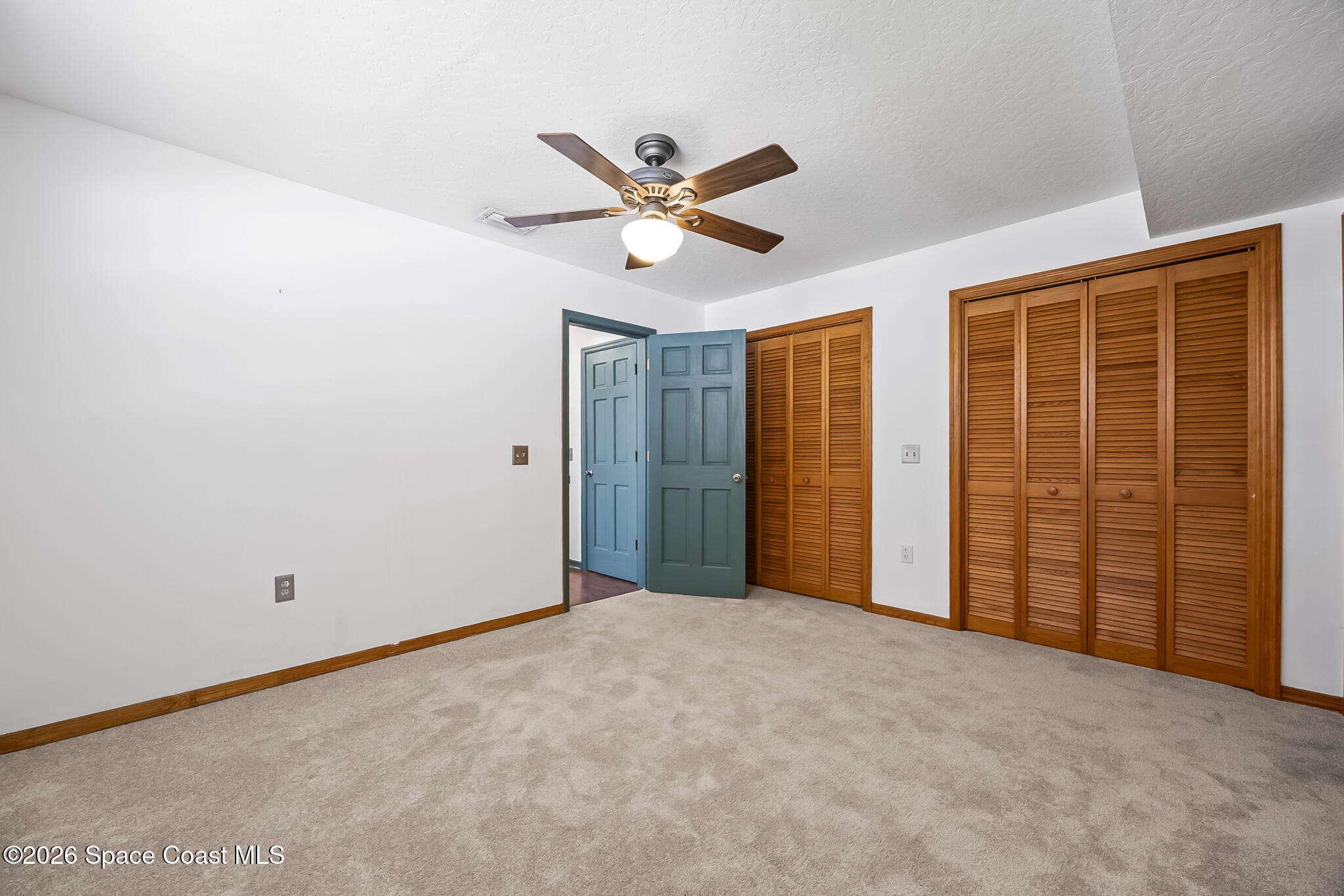 854 Dale Circle Sebastian, FL 32958 - Photo 18 of 31 a view of an empty room with a ceiling fan