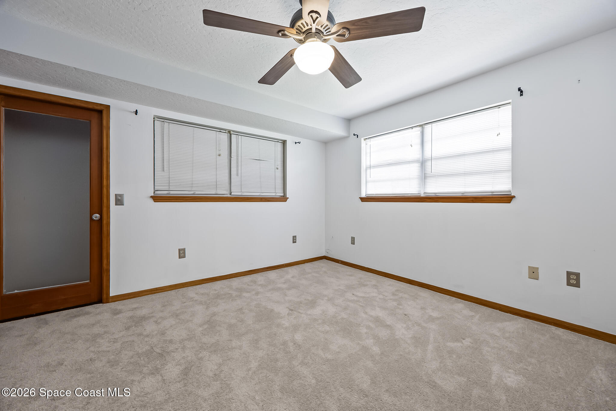 854 Dale Circle Sebastian, FL 32958 - Photo 19 of 31 an empty room with chandelier fan and windows