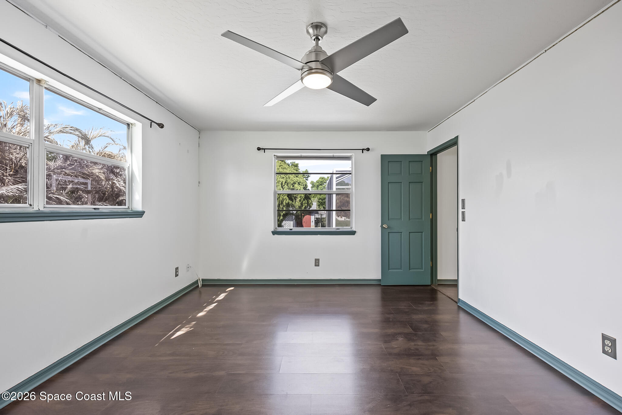 854 Dale Circle Sebastian, FL 32958 - Photo 21 of 31 a view of an empty room with wooden floor and a window