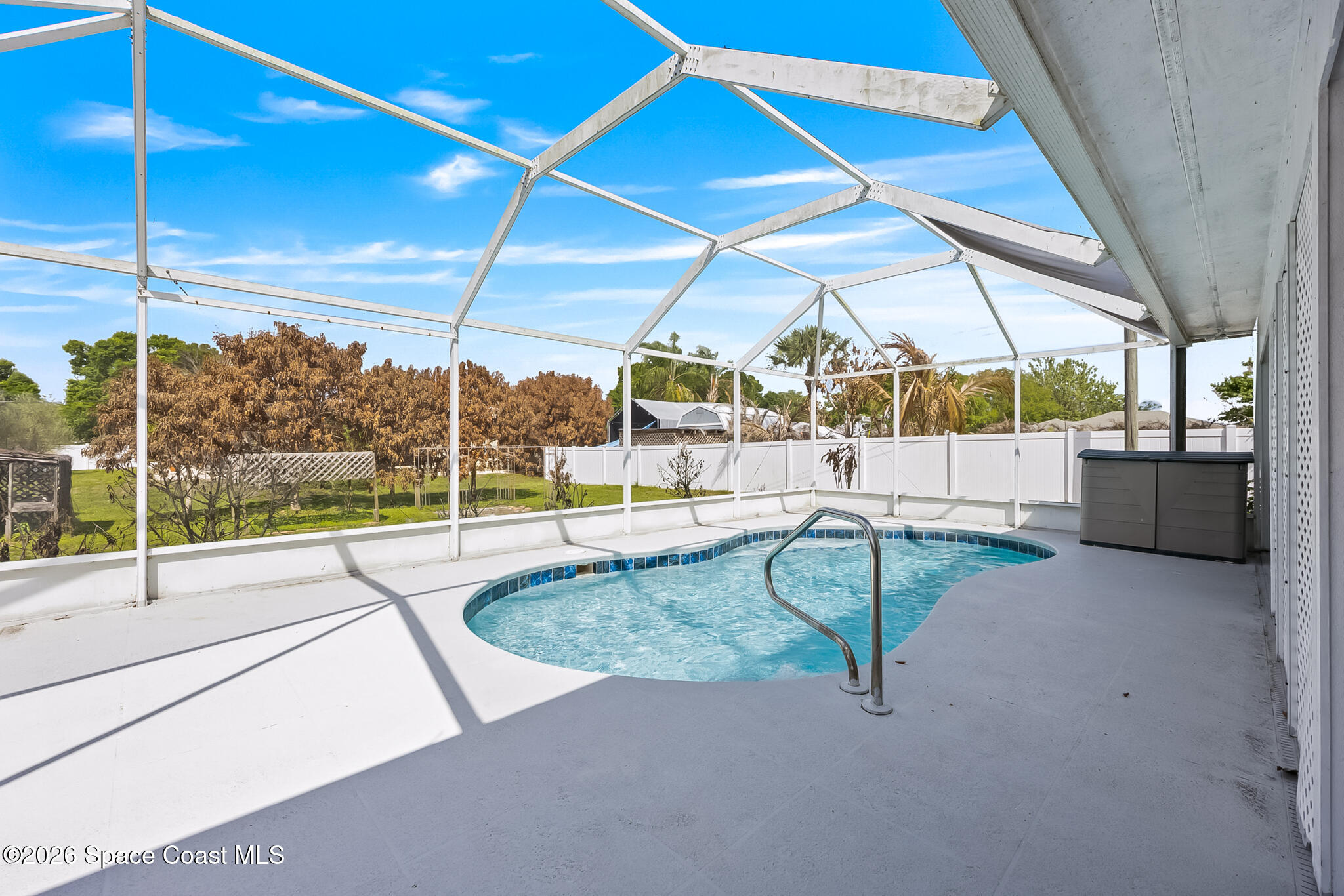 854 Dale Circle Sebastian, FL 32958 - Photo 23 of 31 a view of a living room with a floor to ceiling window and a table